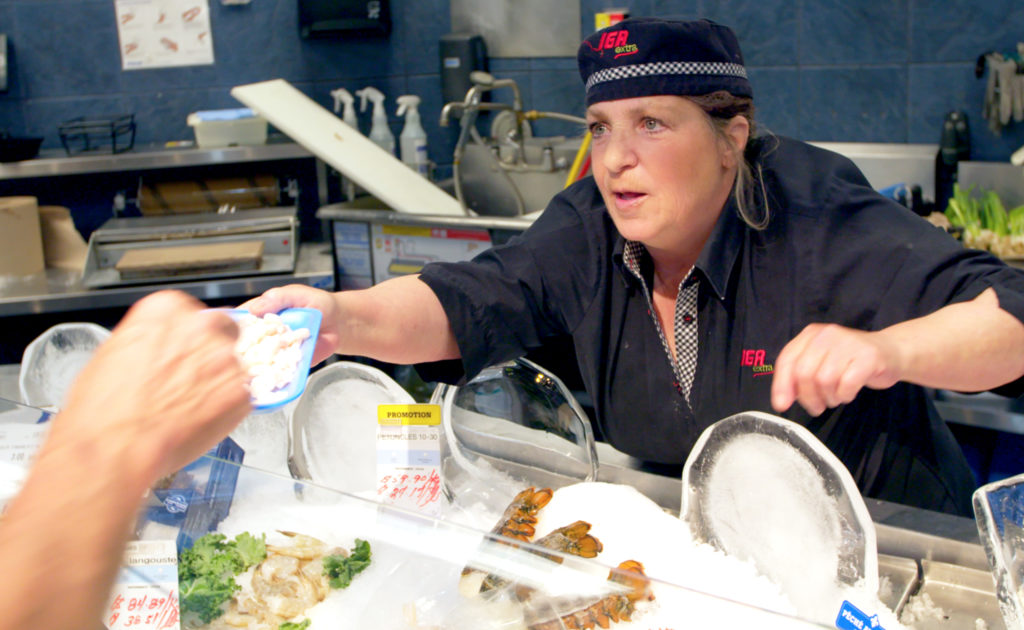 Female IGA Extra employee in seafood